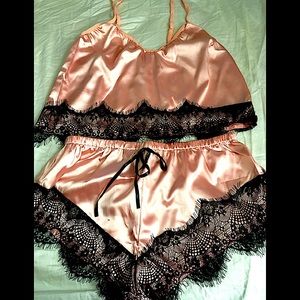 NWT lingerie pink with black lace trimming. Size S